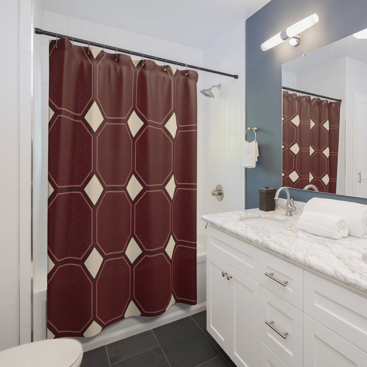 Maroon octagons with rose outlines and cream squares shower curtain beside a white vanity