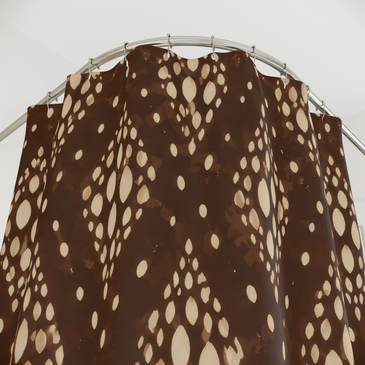 Cream fawn spot medallions over deep coffee brown shower curtain with close-up print, hooks, and folds