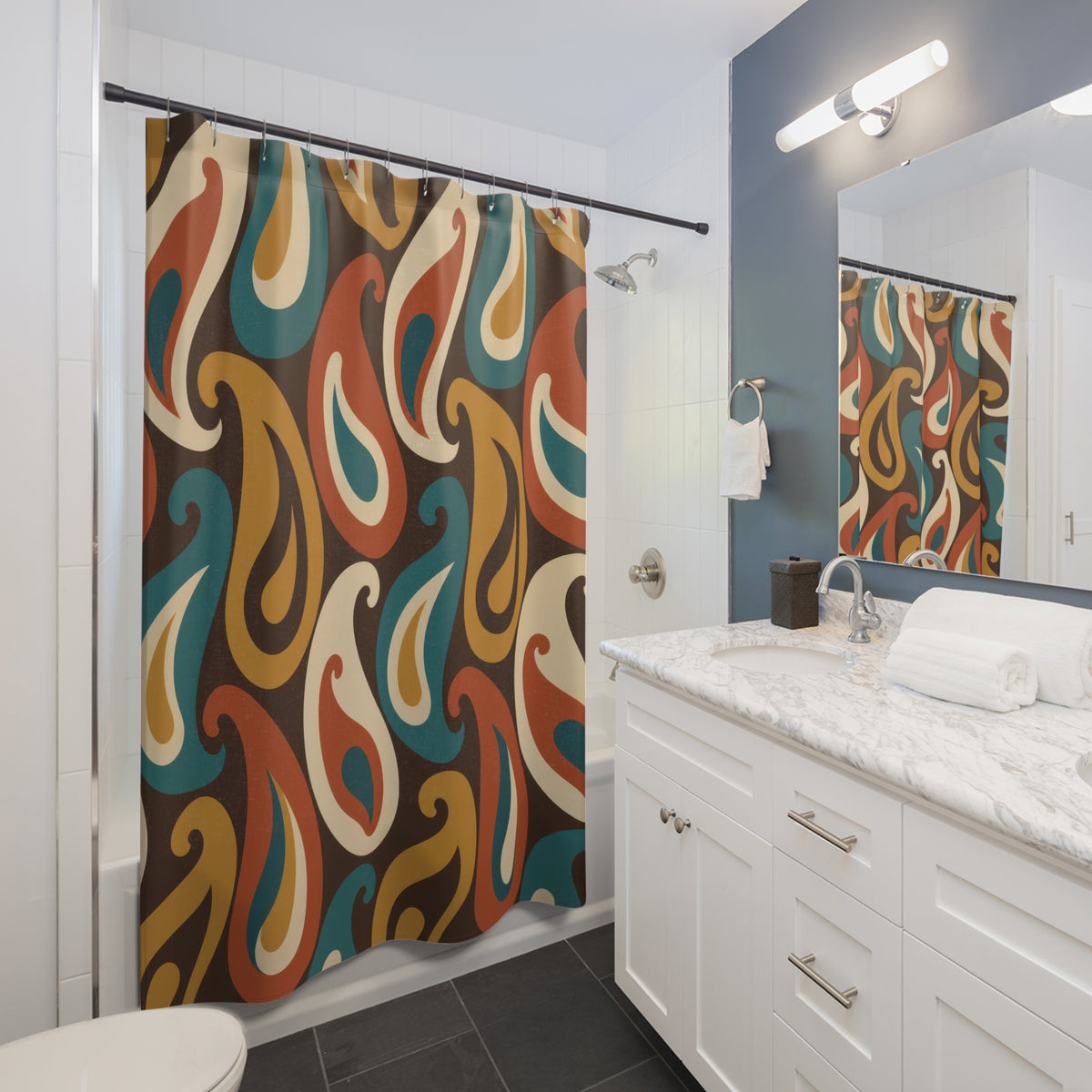 Teal, mustard, rust and cream paisleys on brown shower curtain beside a white vanity