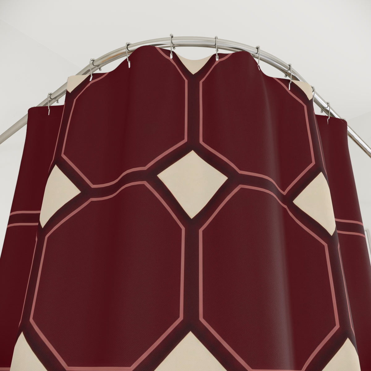 Maroon octagons with rose outlines and cream squares shower curtain with close-up print, hooks, and folds