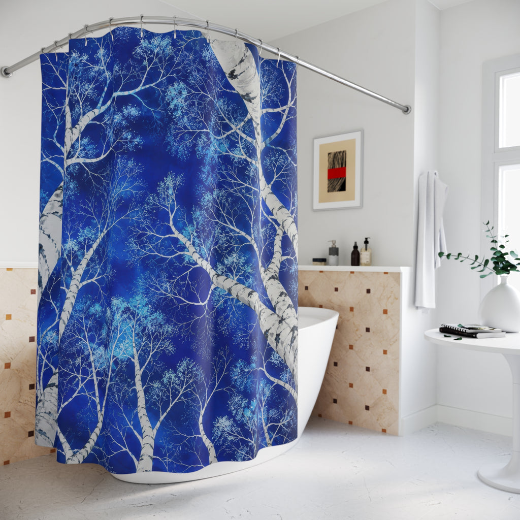 White birch canopy against cobalt blue shower curtain beside a freestanding tub