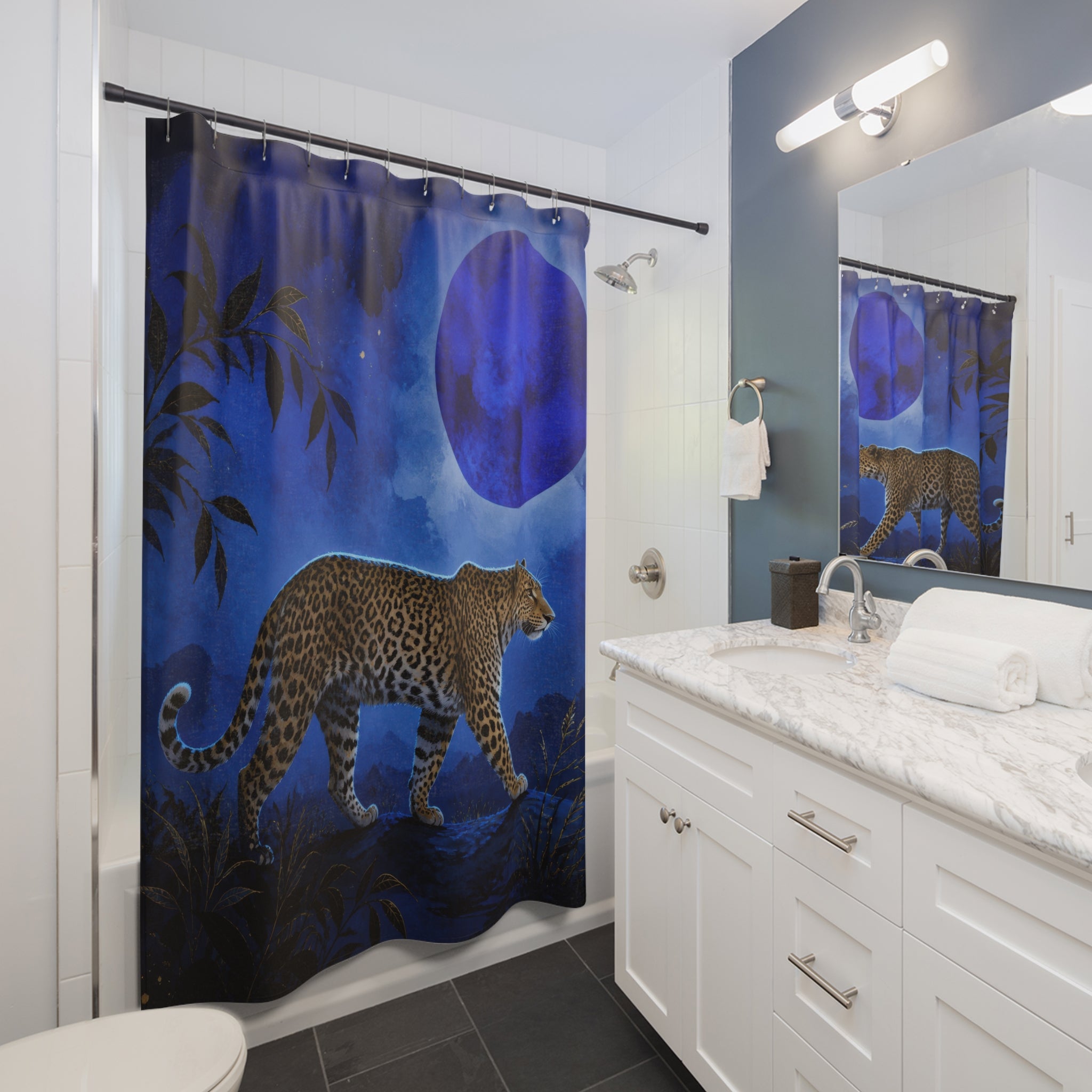 Cobalt moonlit jungle leopard shower curtain beside a white vanity