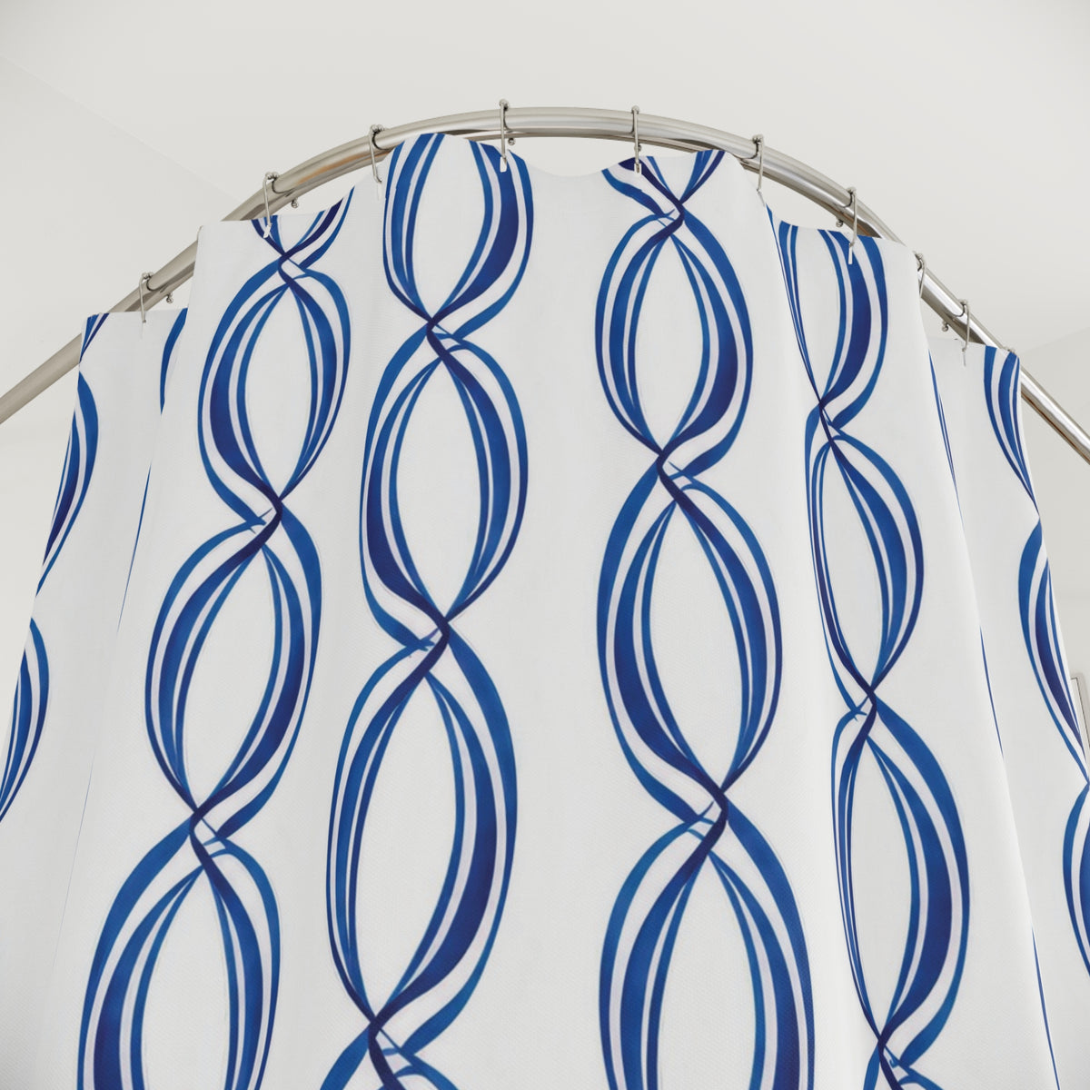 Linked blue oval loops in vertical stripes on white shower curtain with close-up print, hooks, and folds