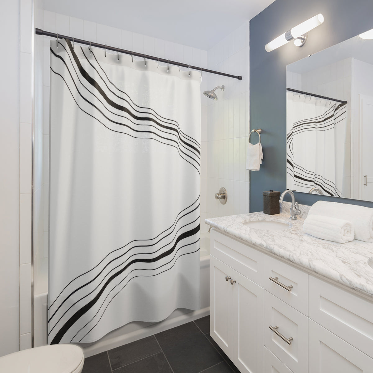 Parallel black stripes sweeping around an open white center shower curtain beside a white vanity
