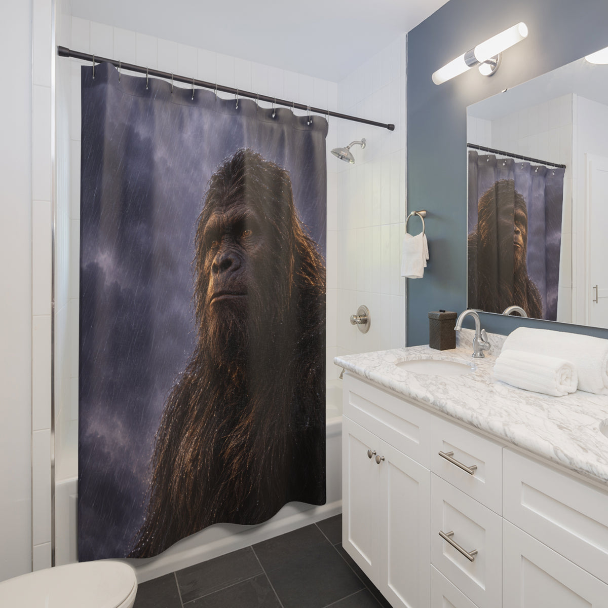 Dark brown Bigfoot portrait against slate-violet rain shower curtain beside a white vanity