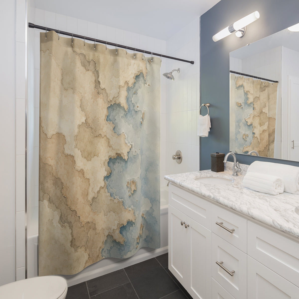 Beige coastline watercolor map shower curtain beside a white vanity
