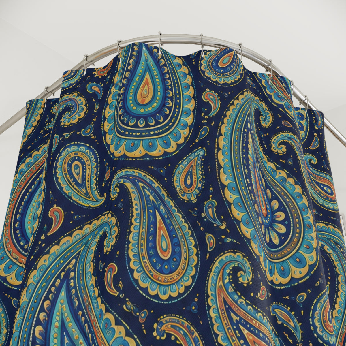 Turquoise paisley with golden yellow detail on navy shower curtain with close-up print, hooks, and folds