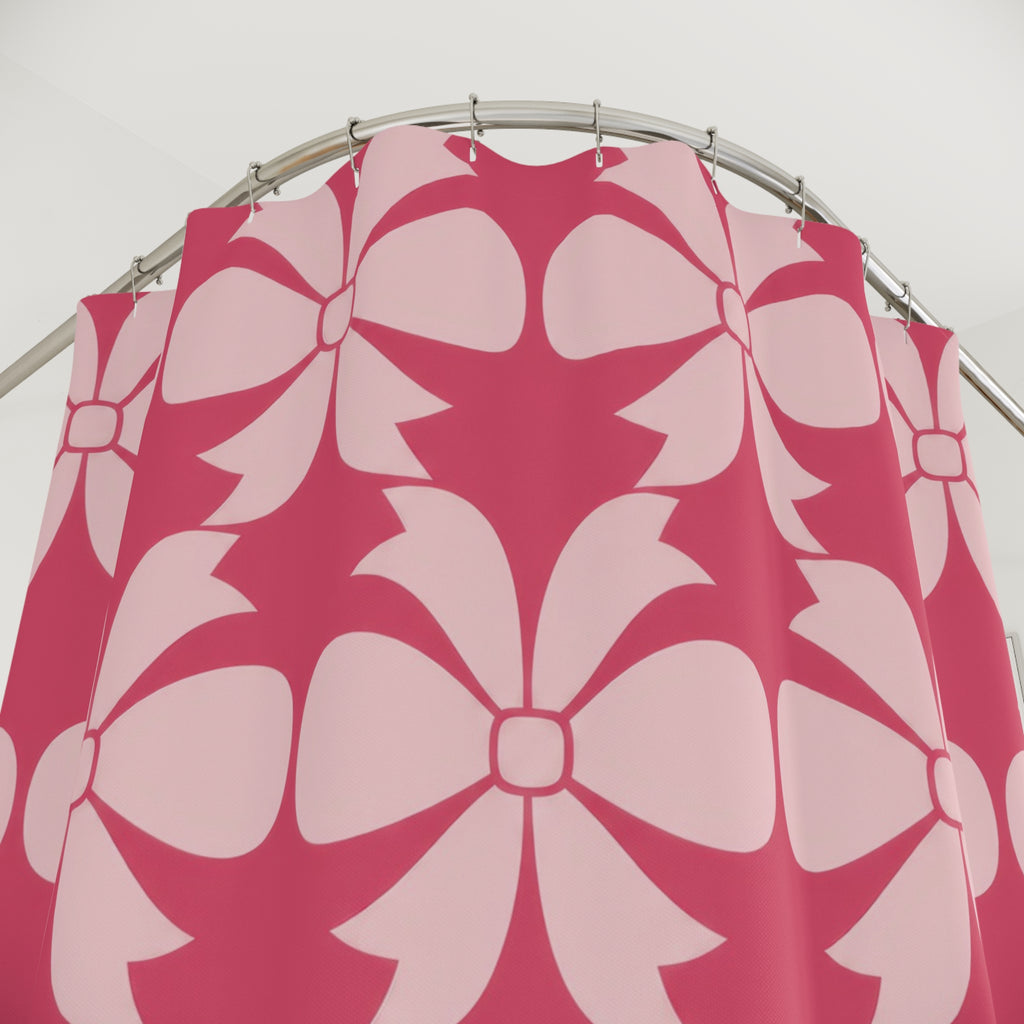 Pale pink bow ornaments on strawberry pink shower curtain with close-up print, hooks, and folds