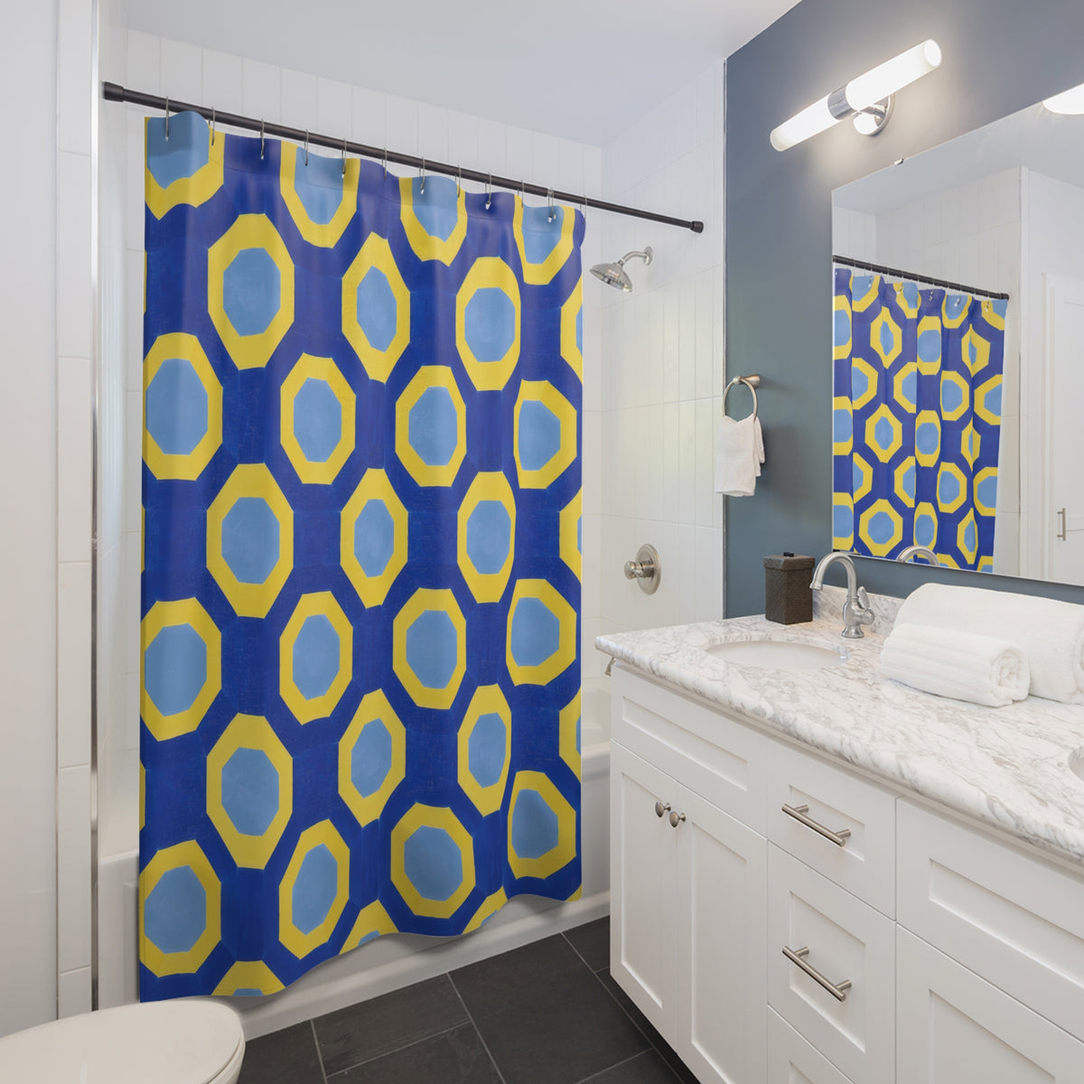 Yellow octagonal bands and pale blue centers on cobalt shower curtain beside a white vanity