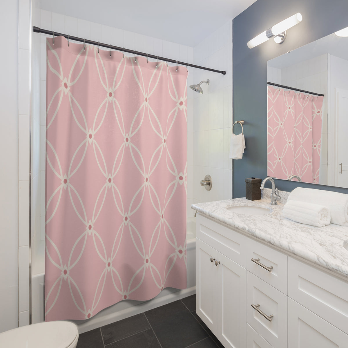 Ivory oval trellis on a light pink ground shower curtain beside a white vanity