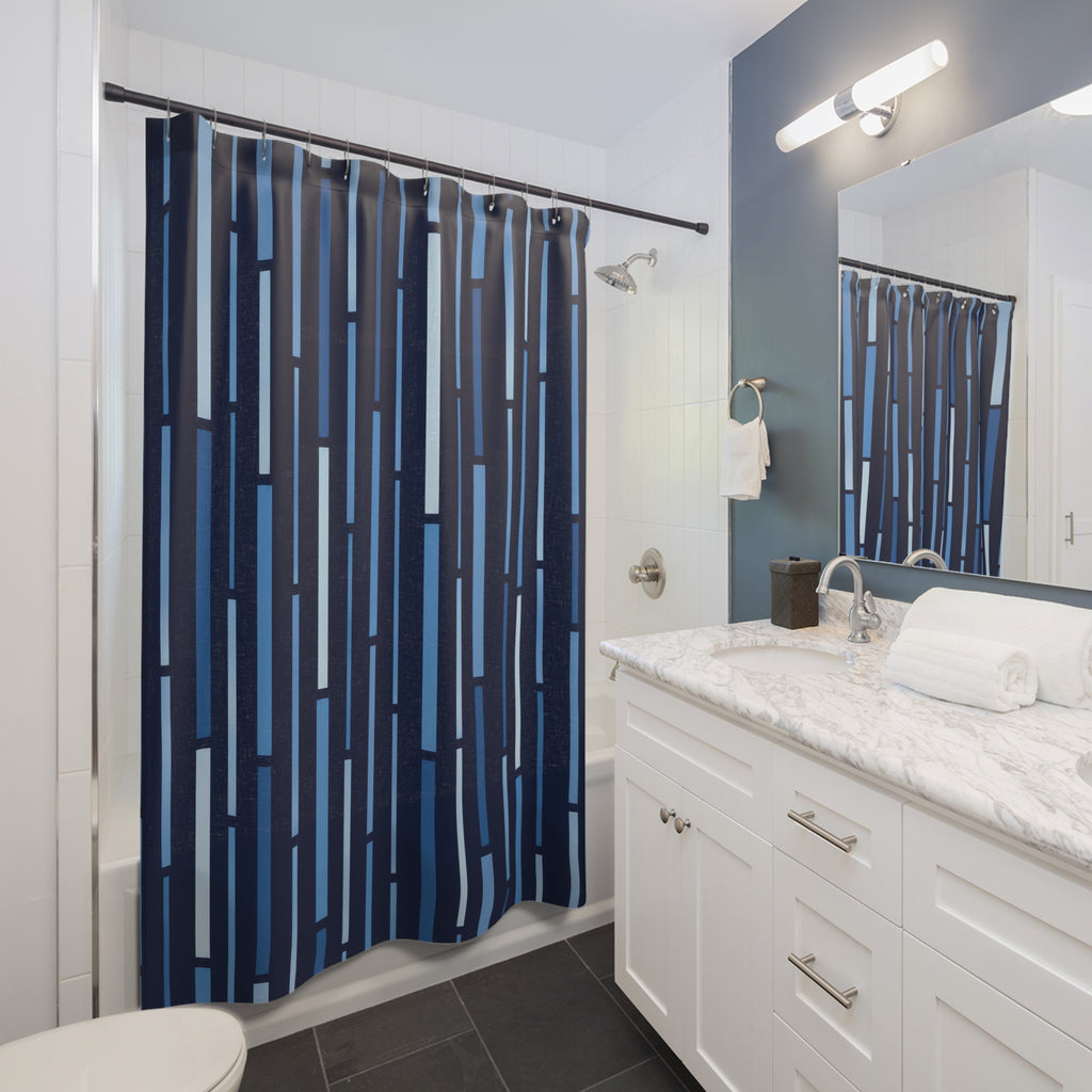 Blue vertical dash stripes on a midnight navy ground shower curtain beside a white vanity