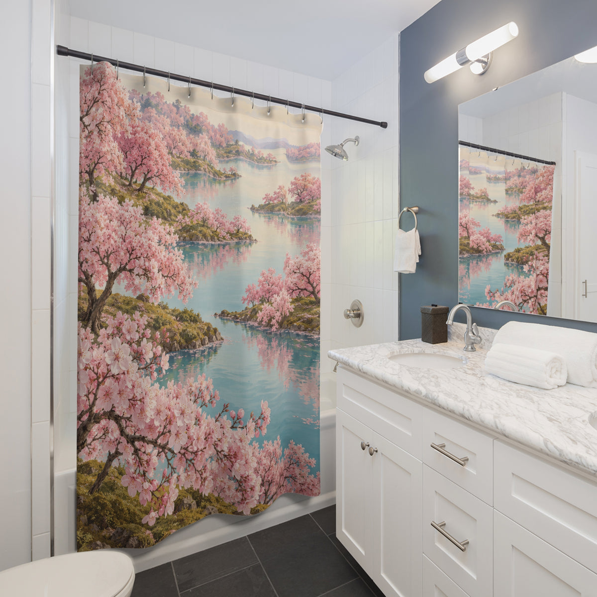 Pink cherry trees reflected in an aqua lake shower curtain beside a white vanity
