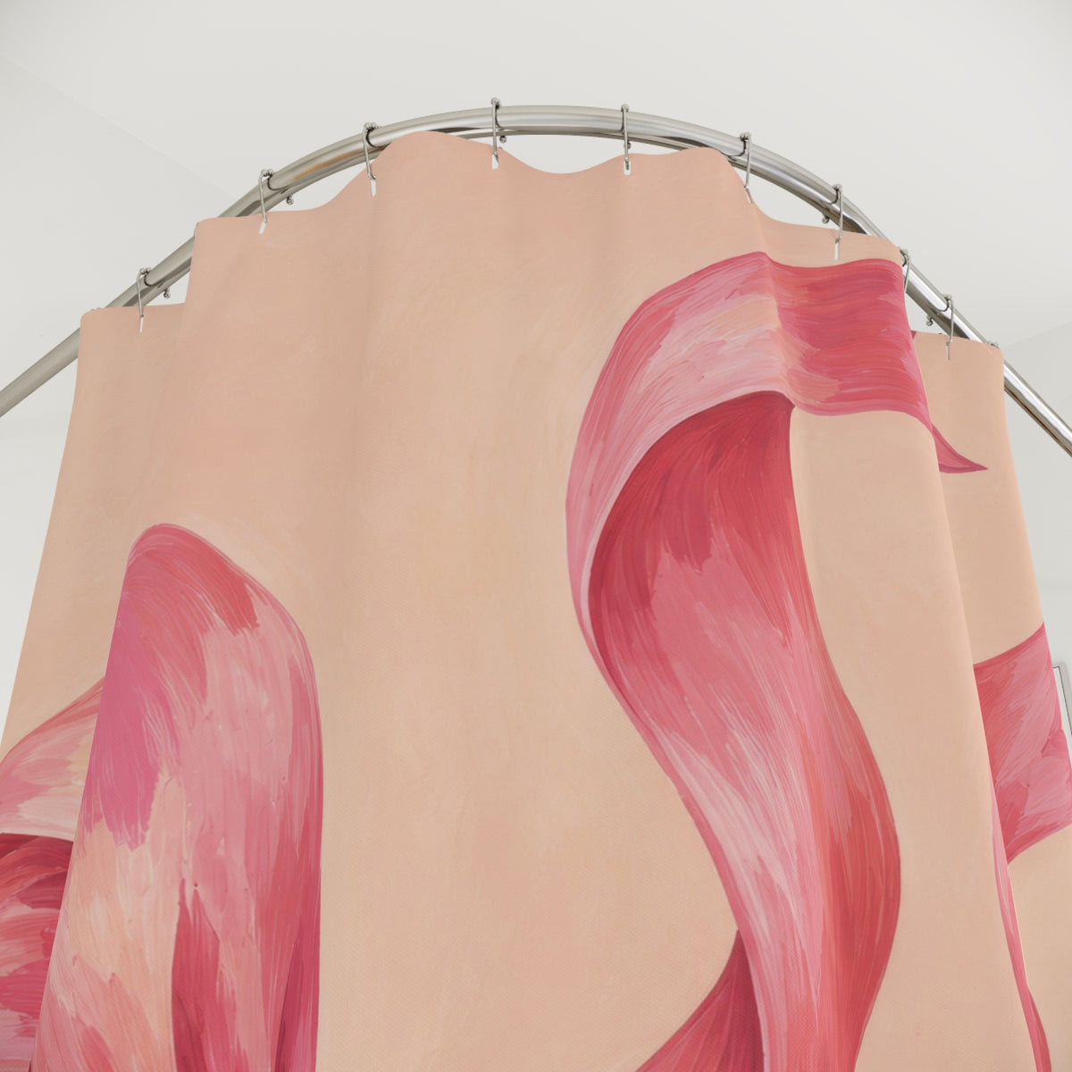Oversized pink bow with curling tails on pale peach shower curtain with close-up print, hooks, and folds