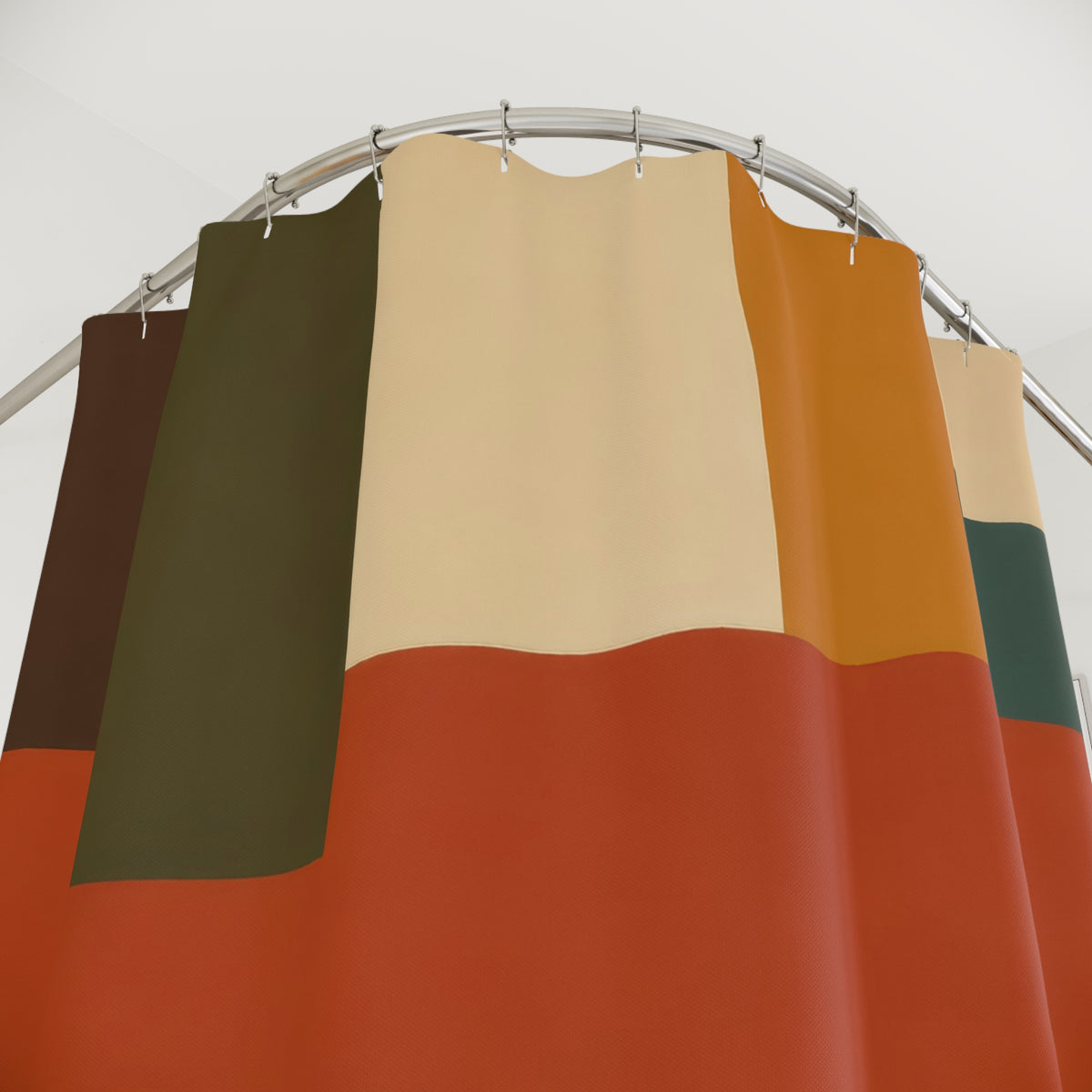 Earth tone interlocking color bands shower curtain with close-up print, hooks, and folds