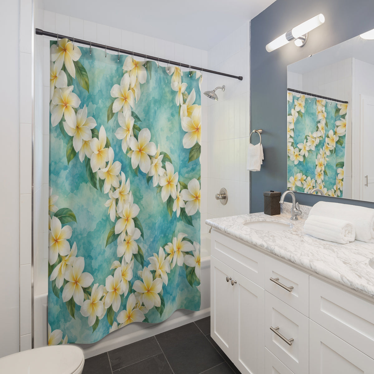 White plumeria leis over aqua watercolor shower curtain beside a white vanity