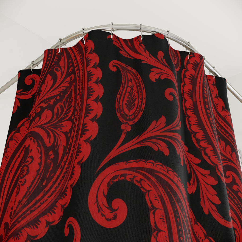 Red paisley teardrops and curling scrollwork on black shower curtain with close-up print, hooks, and folds