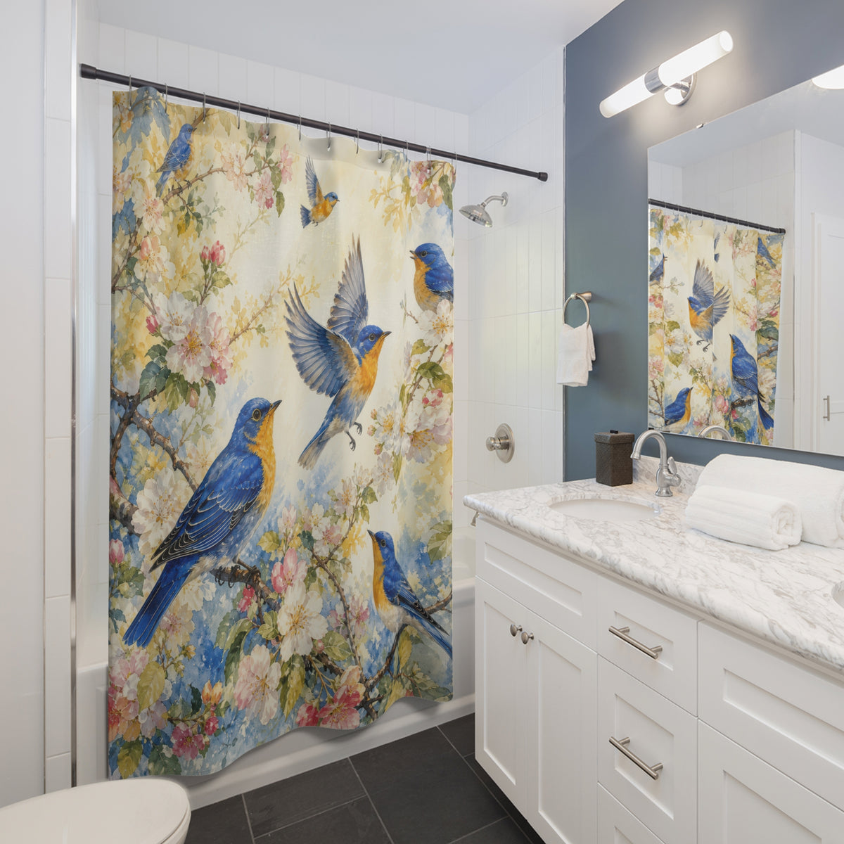 Blue and gold songbirds among blush blossoms on ivory shower curtain installed beside a white vanity
