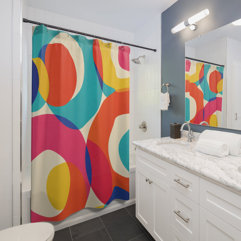 Turquoise, orange, pink and yellow circular bands on cream shower curtain beside a white vanity
