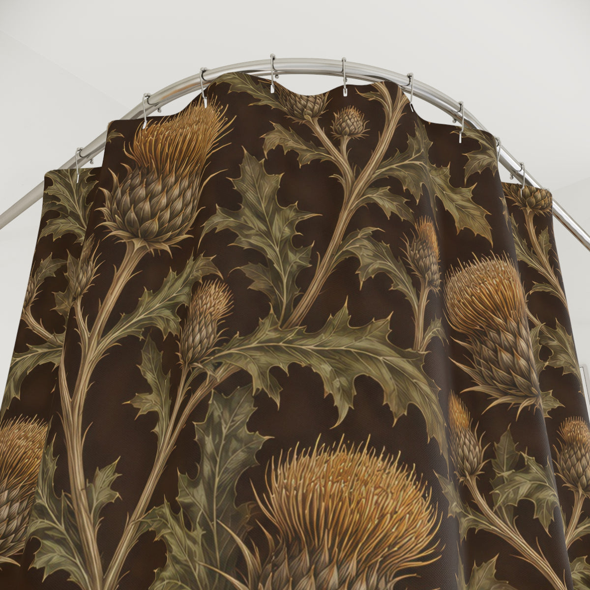 Ochre thistles and olive leaves on deep brown shower curtain with close-up print, hooks, and folds
