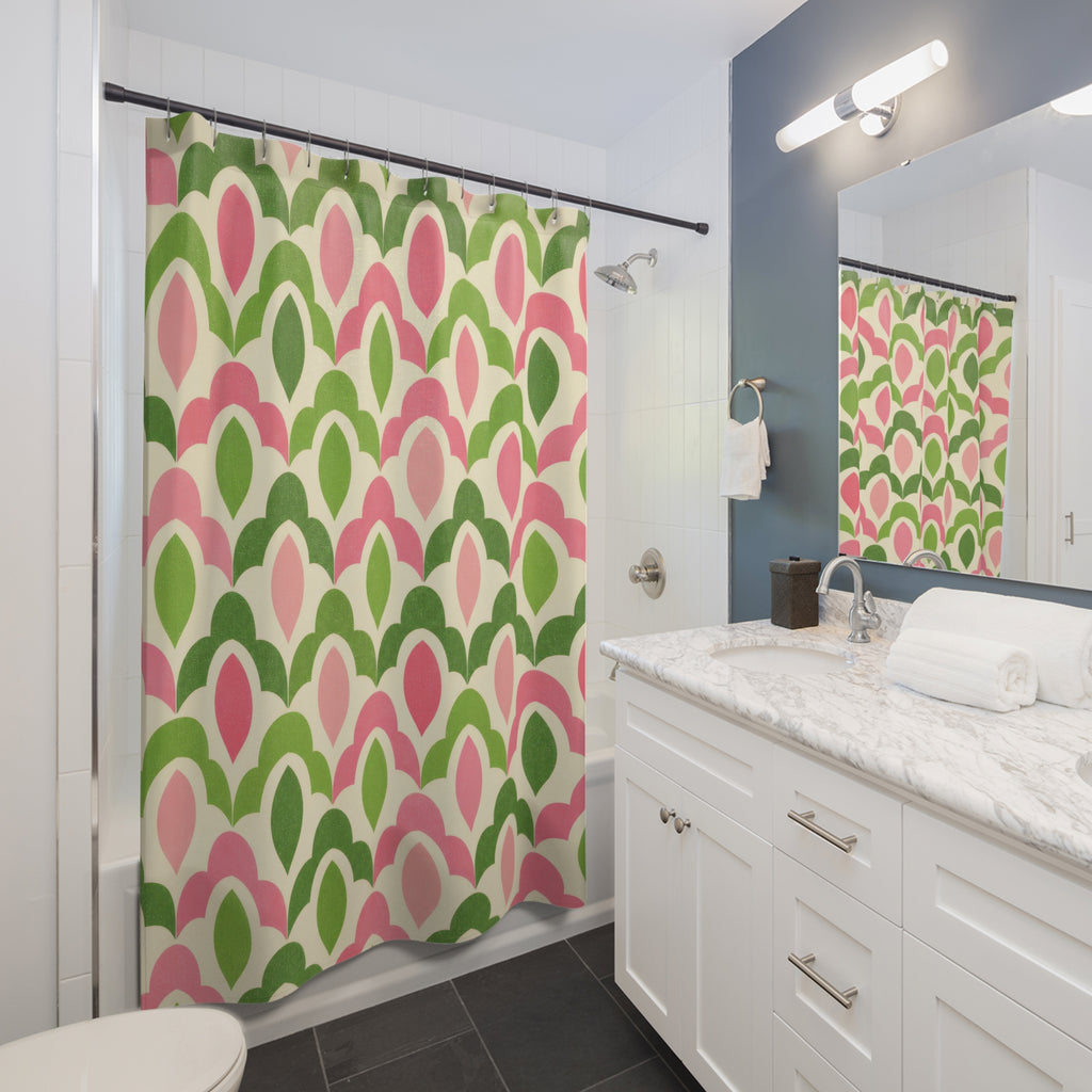 Green and pink interlocking scallop lattice shower curtain beside a white vanity