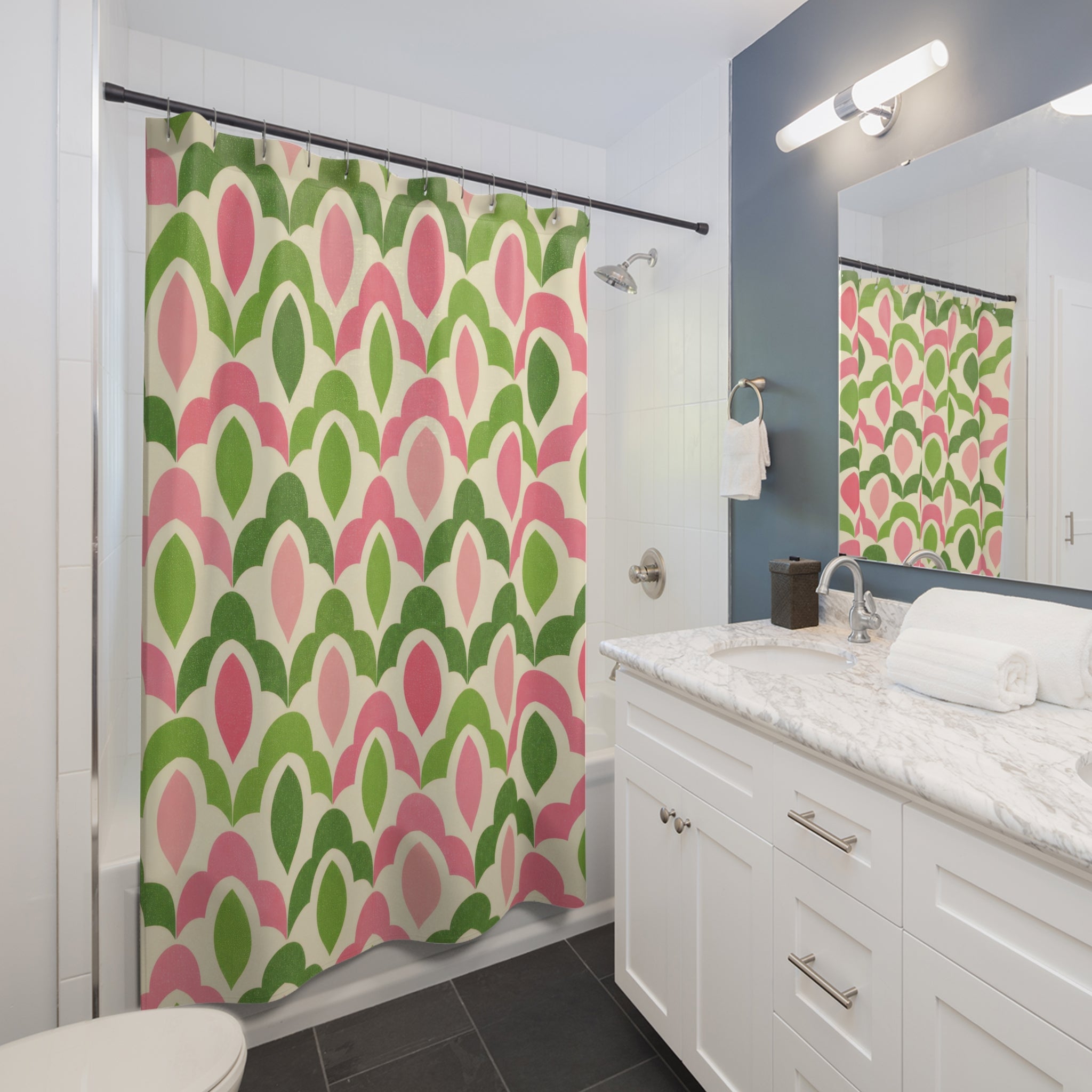 Green and pink interlocking scallop lattice shower curtain beside a white vanity