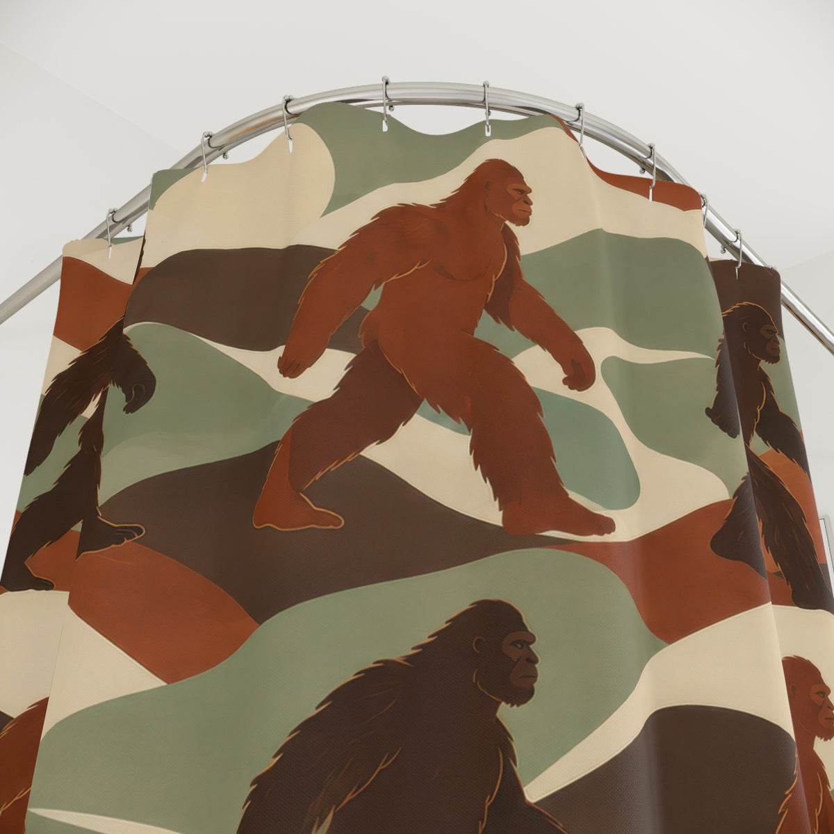 Brown and rust Bigfoot figures among sage and ivory ridges shower curtain with close-up print, hooks, and folds