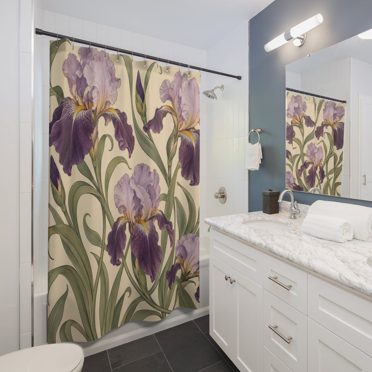 Lavender and plum irises with curling sage leaves on cream shower curtain beside a white vanity