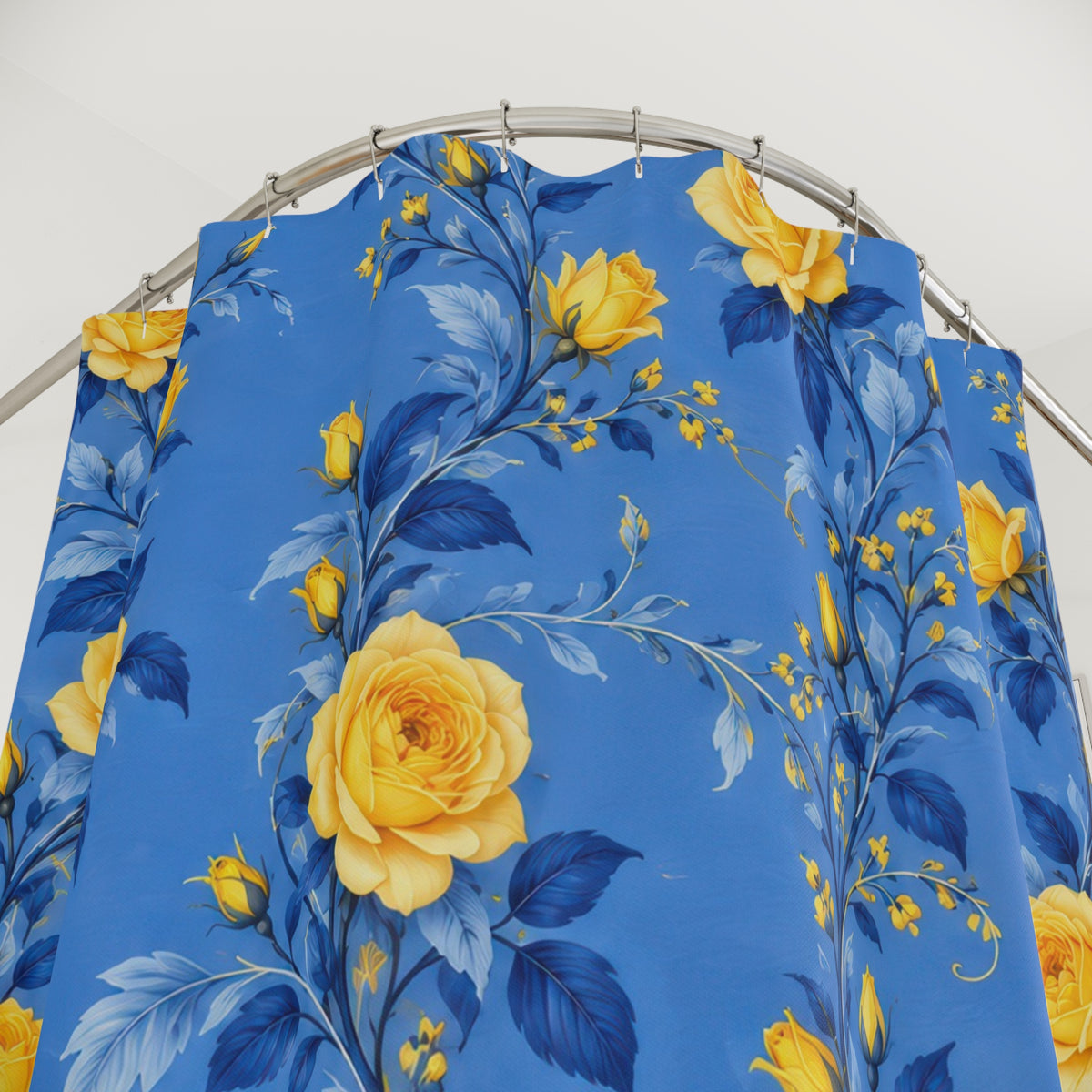Yellow rose garlands with blue leaves on cornflower blue shower curtain with close-up print, hooks, and folds