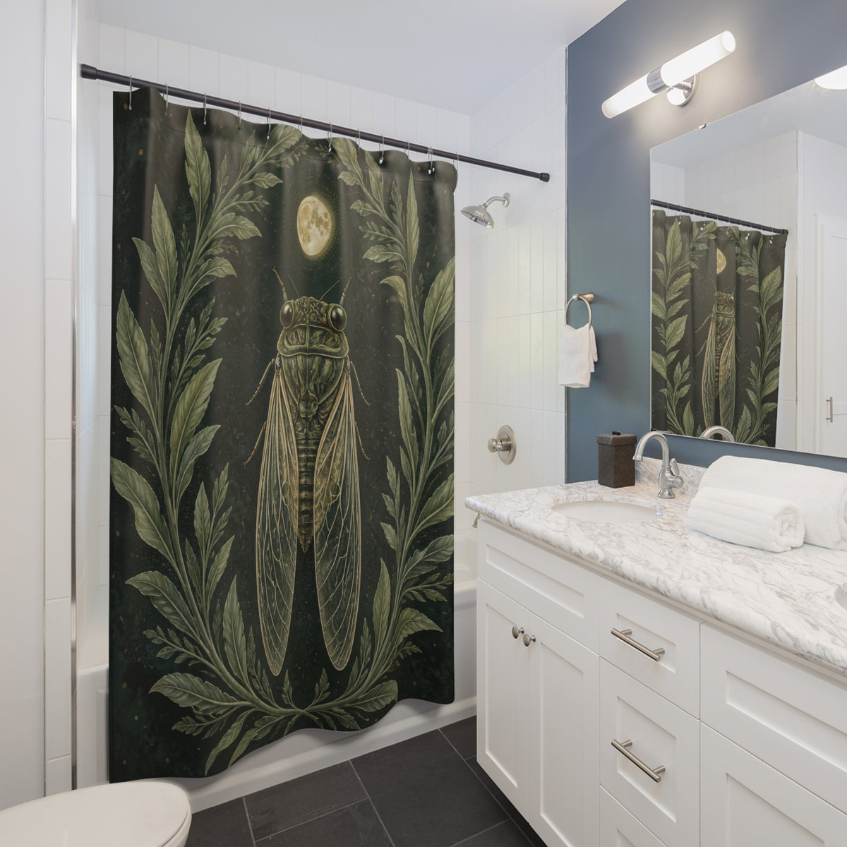 Cicada beneath a pale moon framed by sage leaves shower curtain beside a white vanity