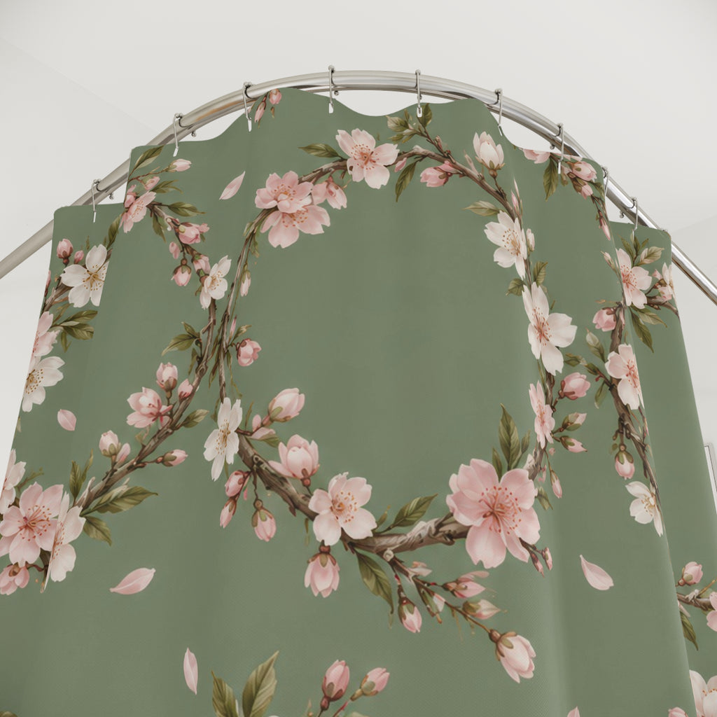 Cream and pink cherry blossom wreaths on sage green shower curtain with close-up print, hooks, and folds