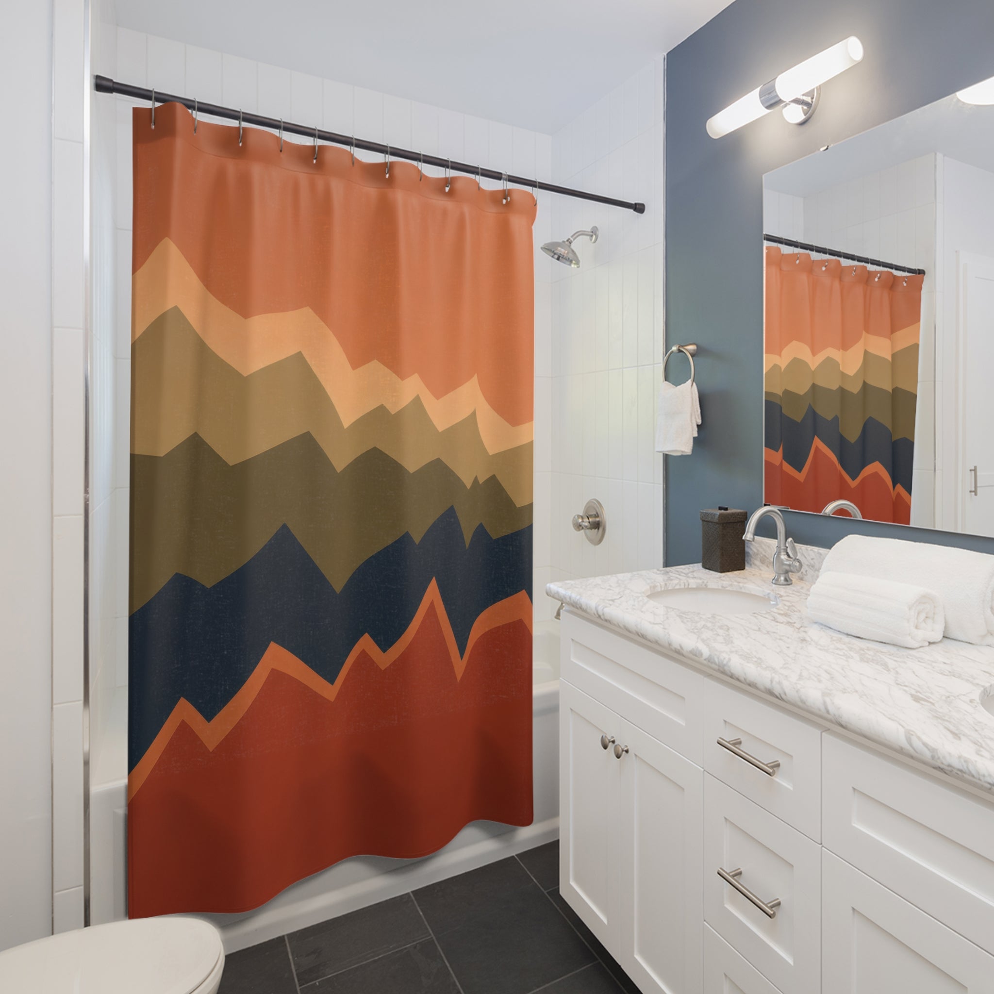 Rust olive and blue stacked broken zigzag horizons shower curtain beside a white vanity