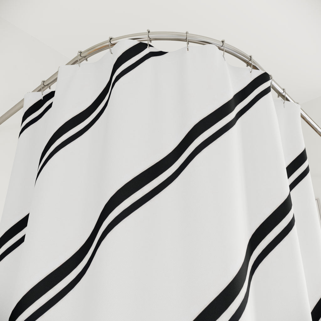 Paired black diagonal stripes across a white field shower curtain with close-up print, hooks, and folds