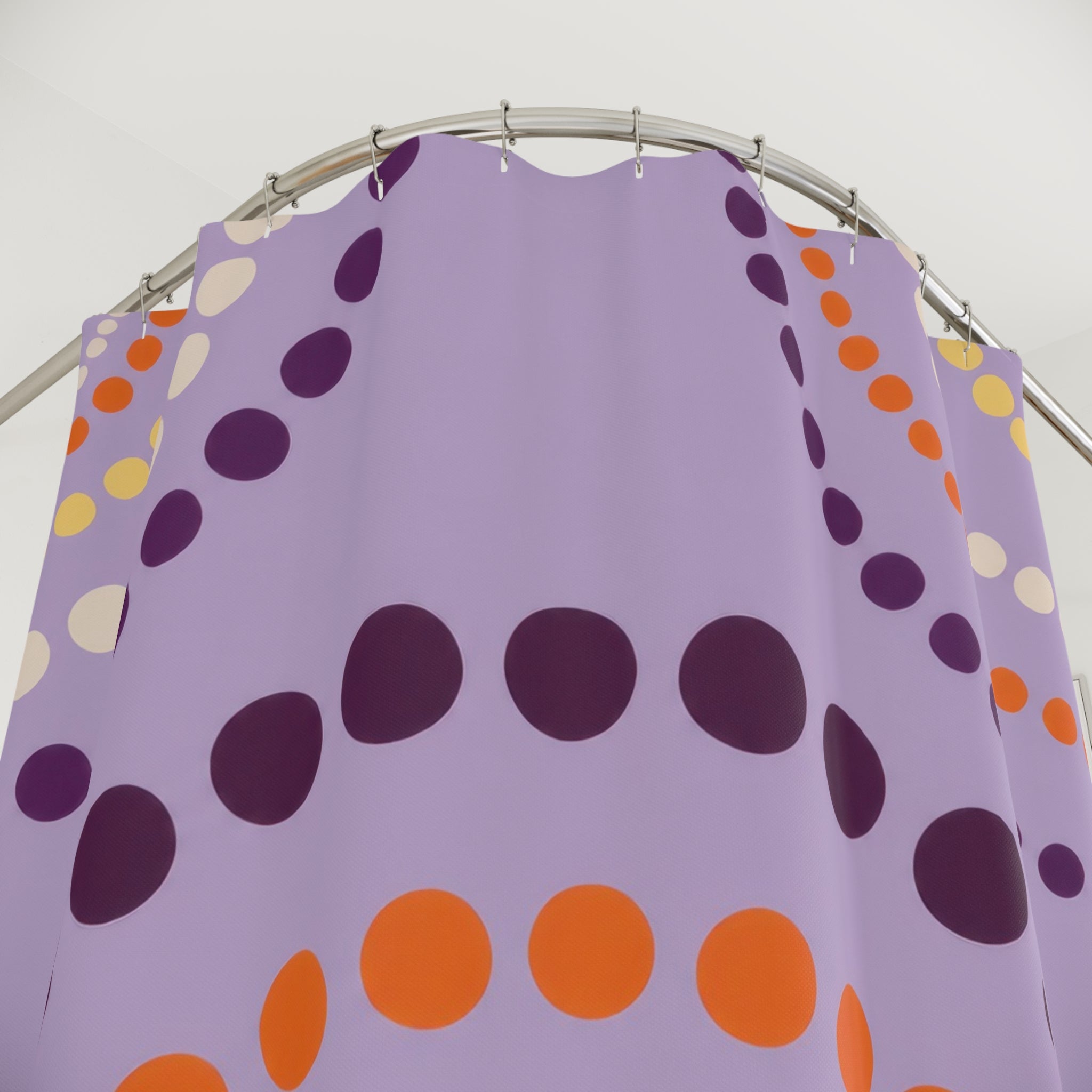 Purple polka dot arches with orange accents shower curtain with close-up print, hooks, and folds