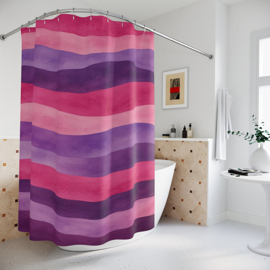 Wavy watercolor stripes in pink, lavender and plum shower curtain beside a freestanding tub