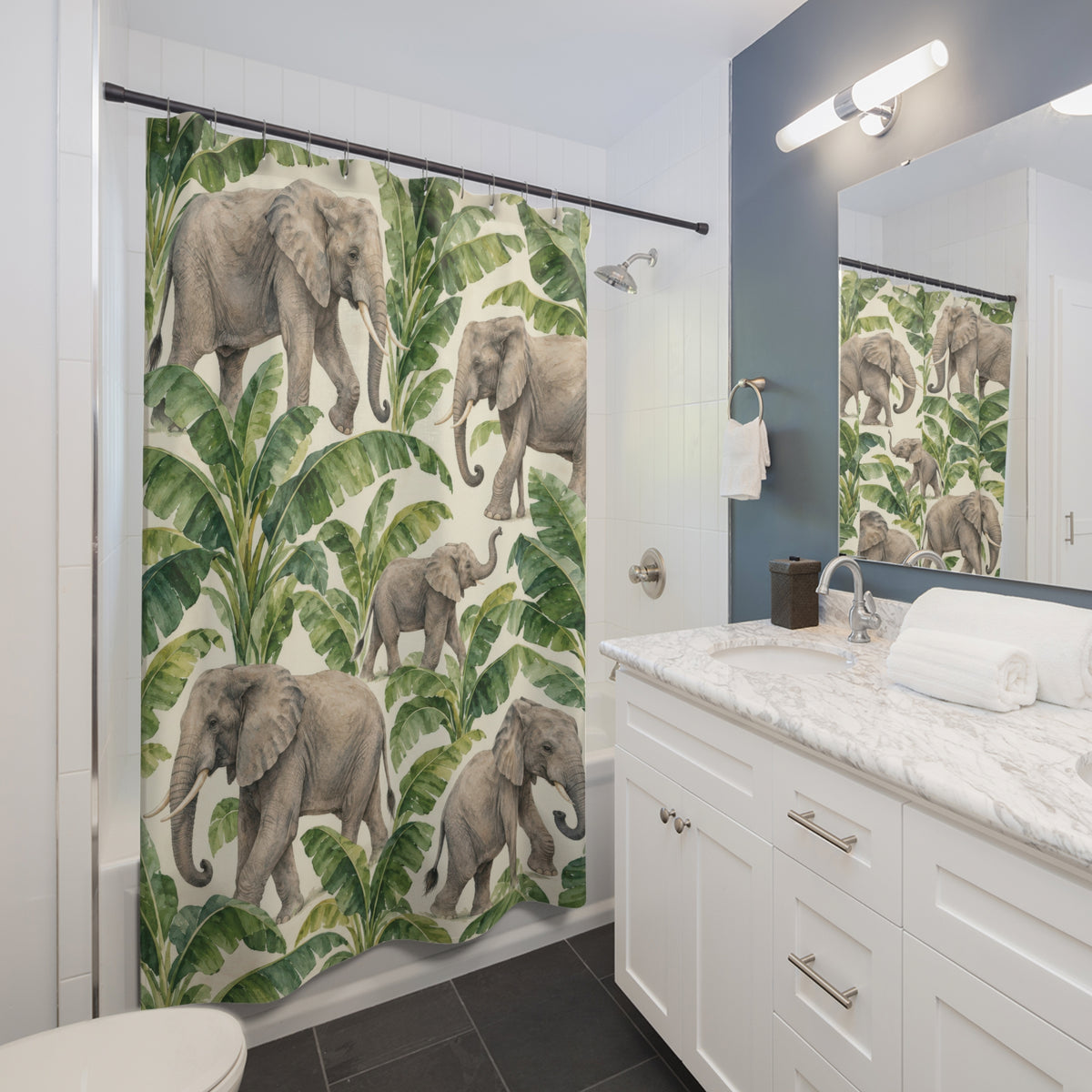 Elephant and green banana leaf pattern shower curtain beside a white vanity