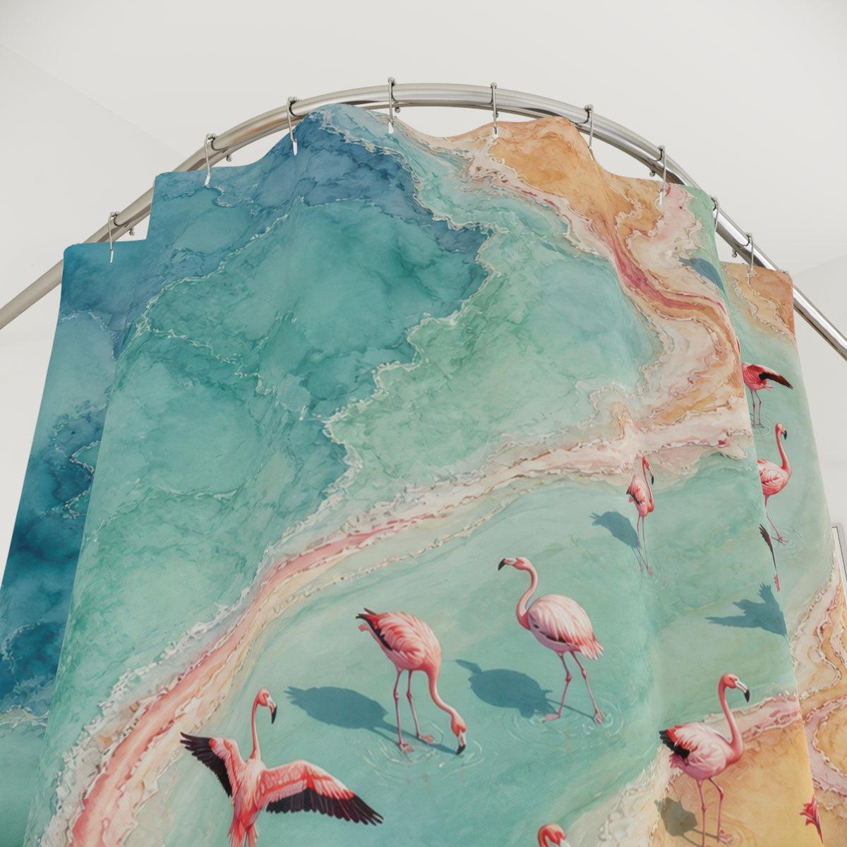 Aerial flamingo flock following an aqua tidal ribbon shower curtain with close-up print, hooks, and folds