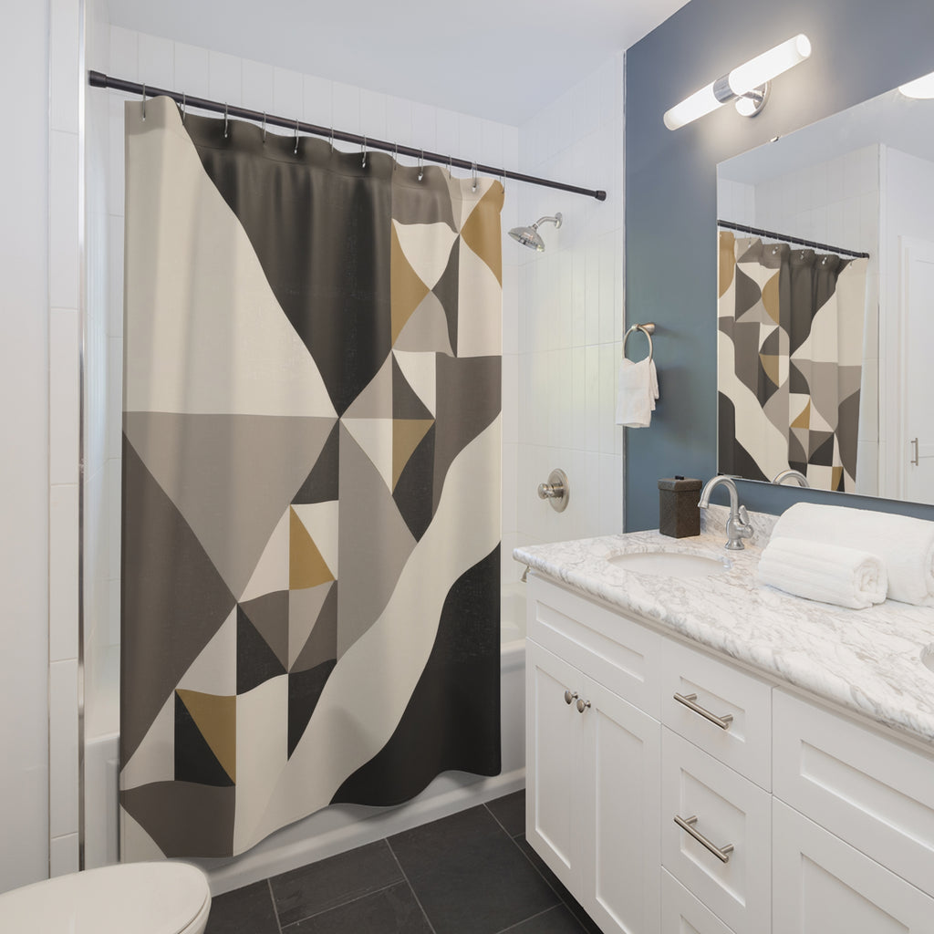 Geometric triangles in charcoal, ivory, taupe and ochre shower curtain beside a white vanity