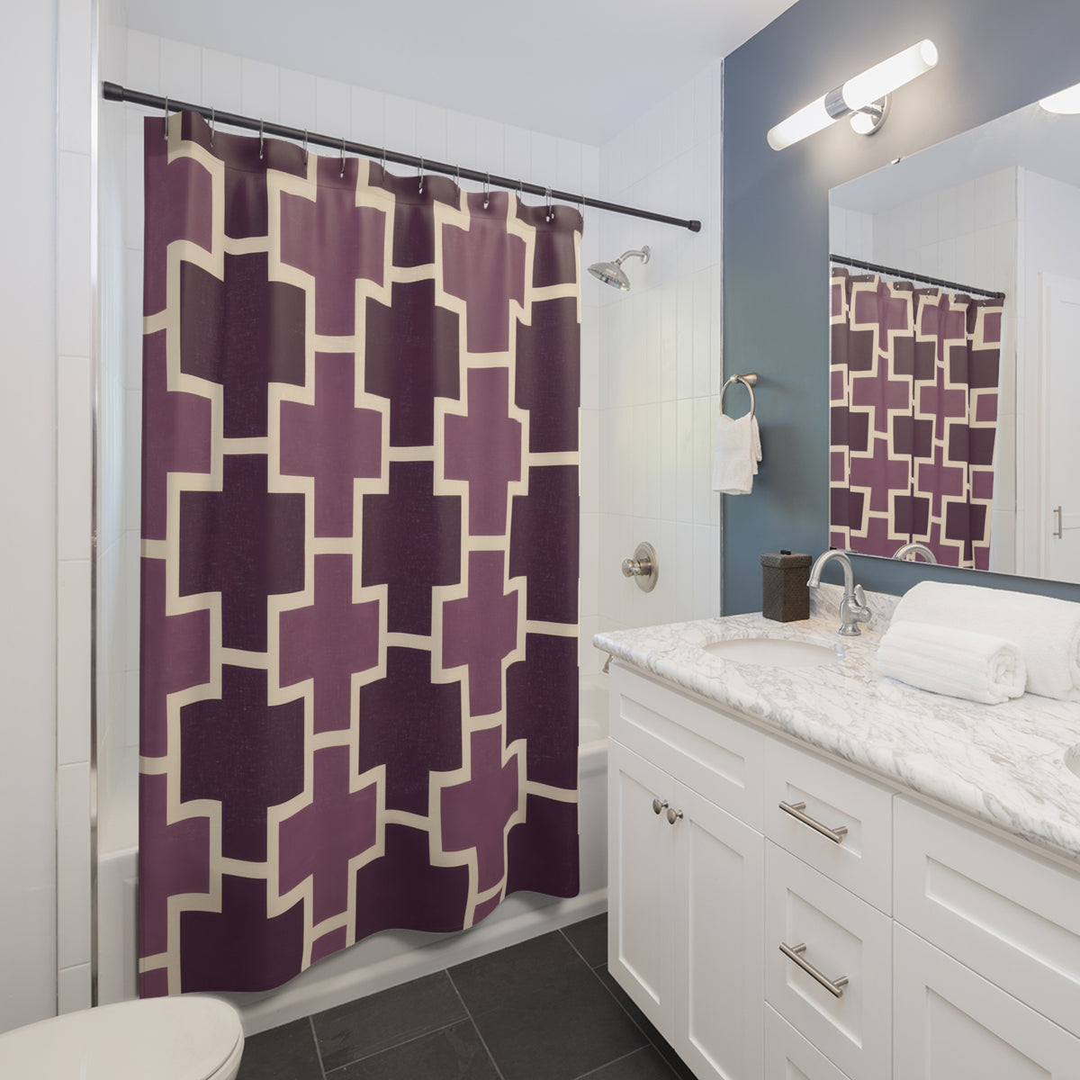 Plum crosses with cream outlines shower curtain beside a white vanity