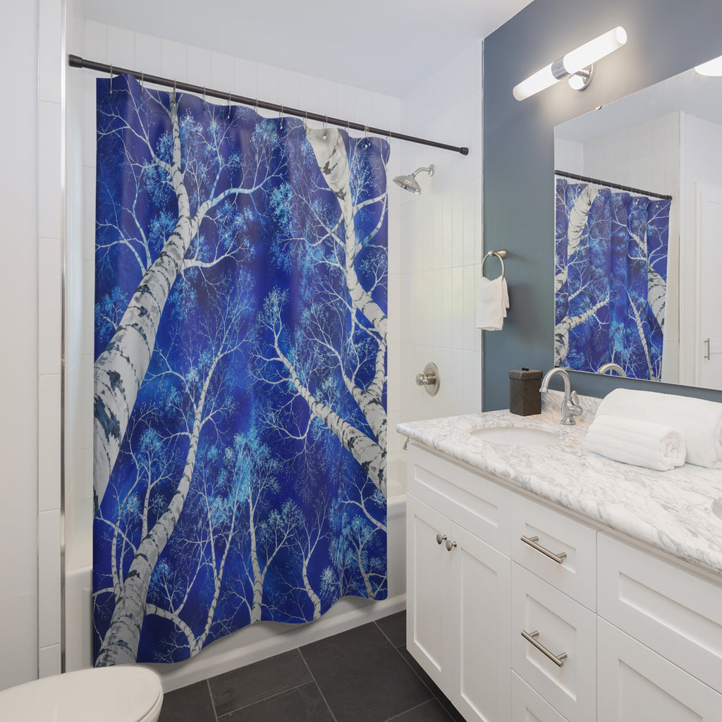 White birch canopy against cobalt blue shower curtain beside a white vanity