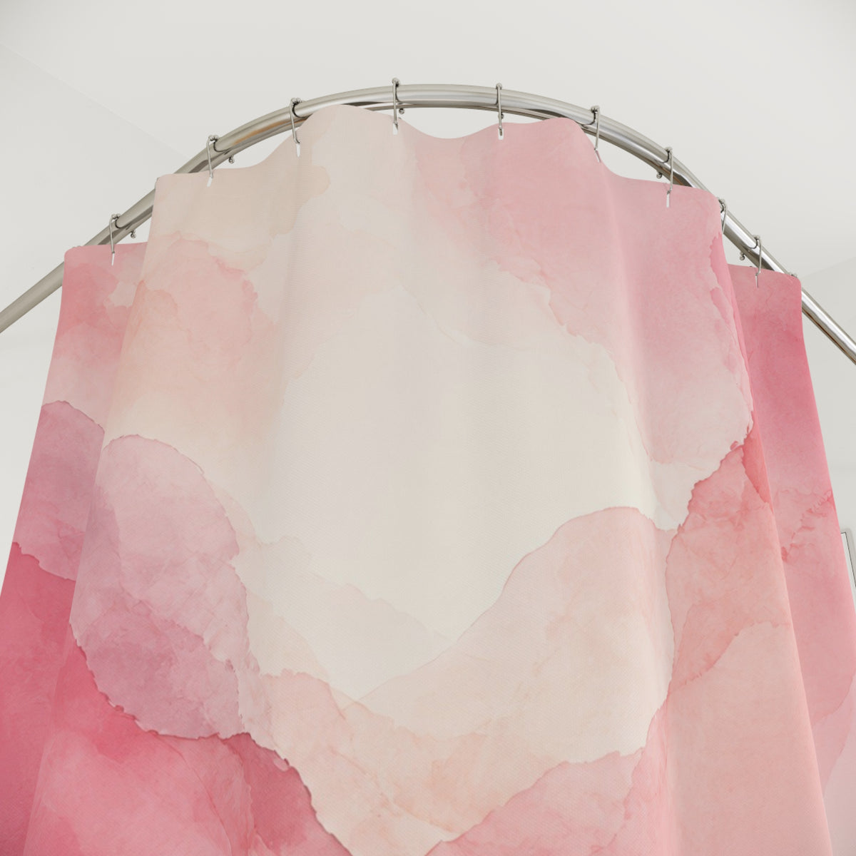 Light pink watercolor washes with mauve edges shower curtain with close-up print, hooks, and folds