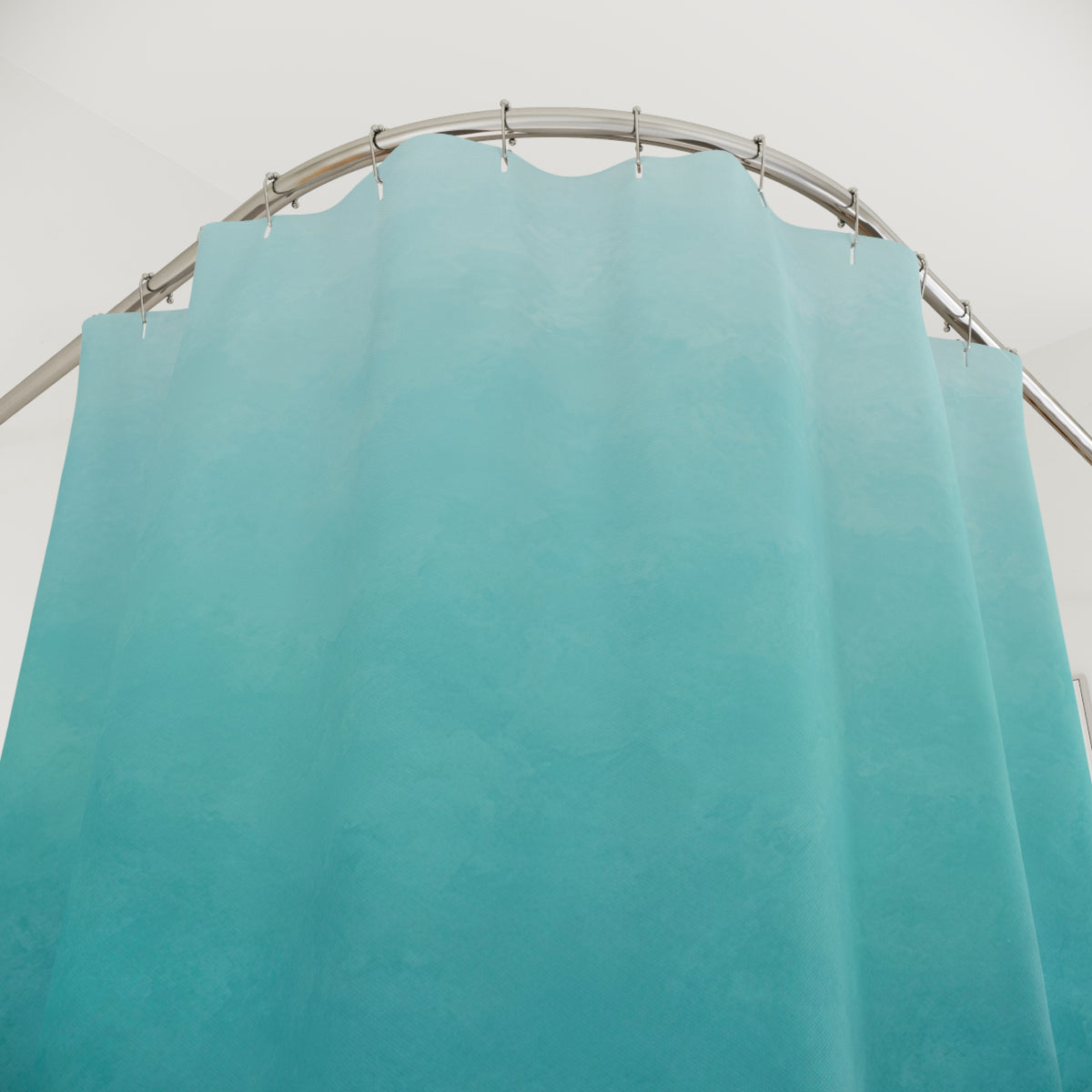 Aqua to deep blue ombre with teal midtones shower curtain with close-up print, hooks, and folds
