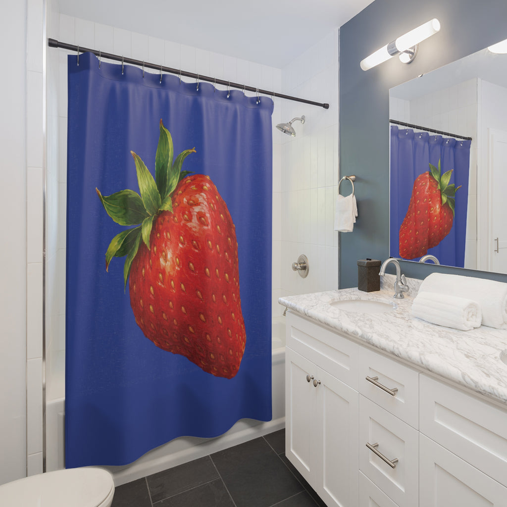Single red strawberry with green crown on cobalt blue shower curtain beside a white vanity