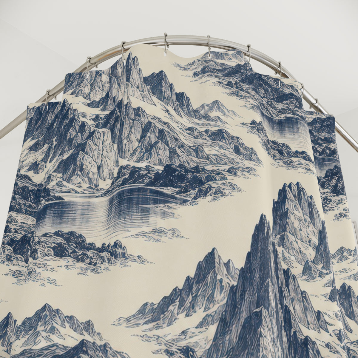 Indigo mountain and lake toile on ivory shower curtain with close-up print, hooks, and folds