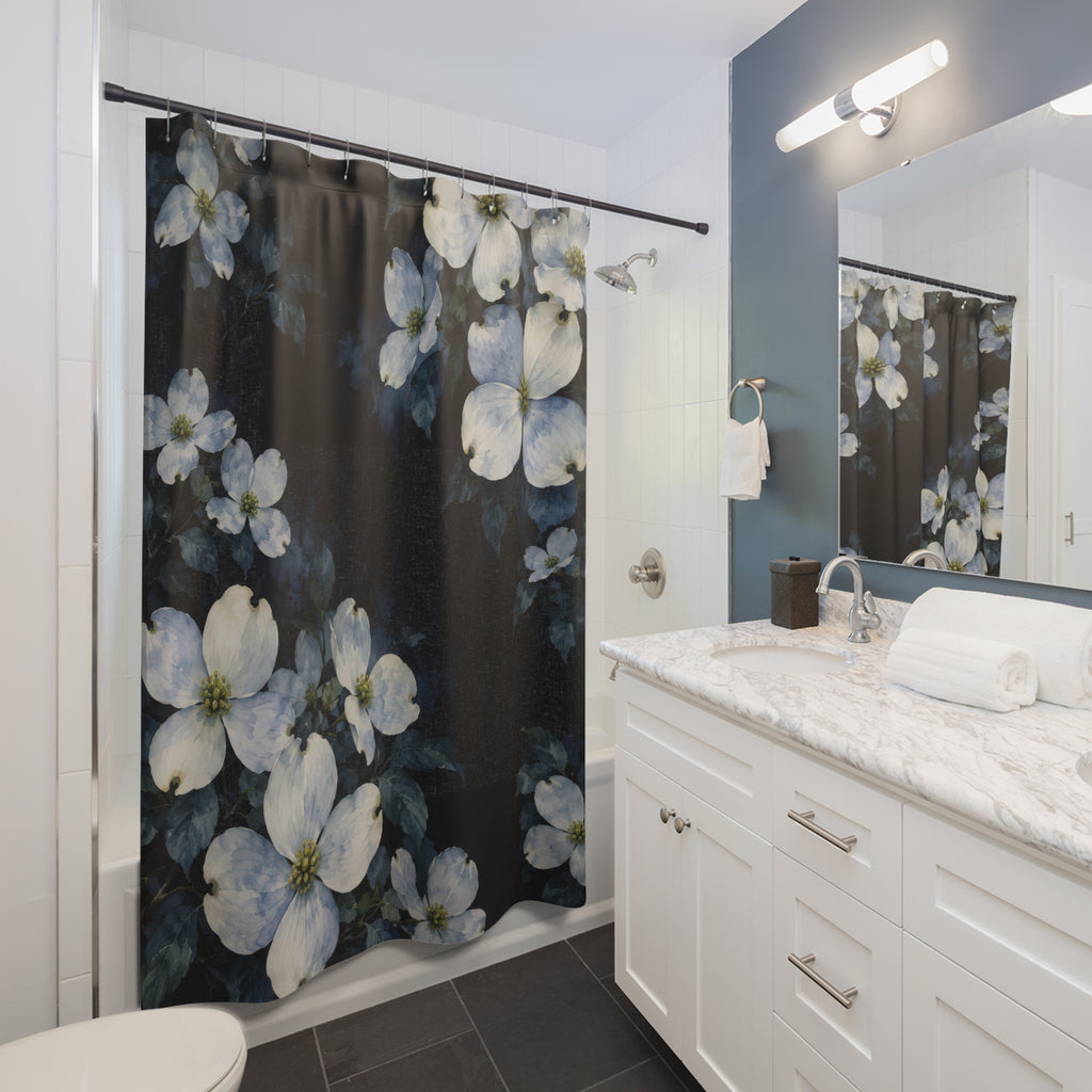Pale blue and cream dogwood clusters on inky indigo shower curtain beside a white vanity