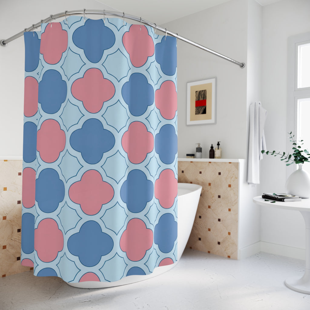 Blue and pink quatrefoils on a pale blue ground shower curtain beside a freestanding tub