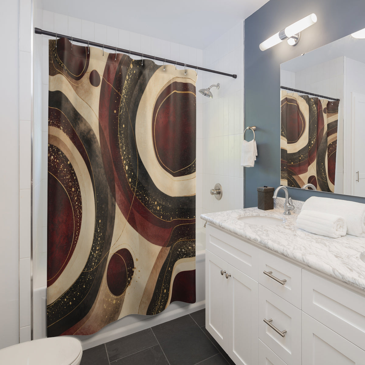 Burgundy circles with cream bands and gold-colored flecks shower curtain beside a white vanity