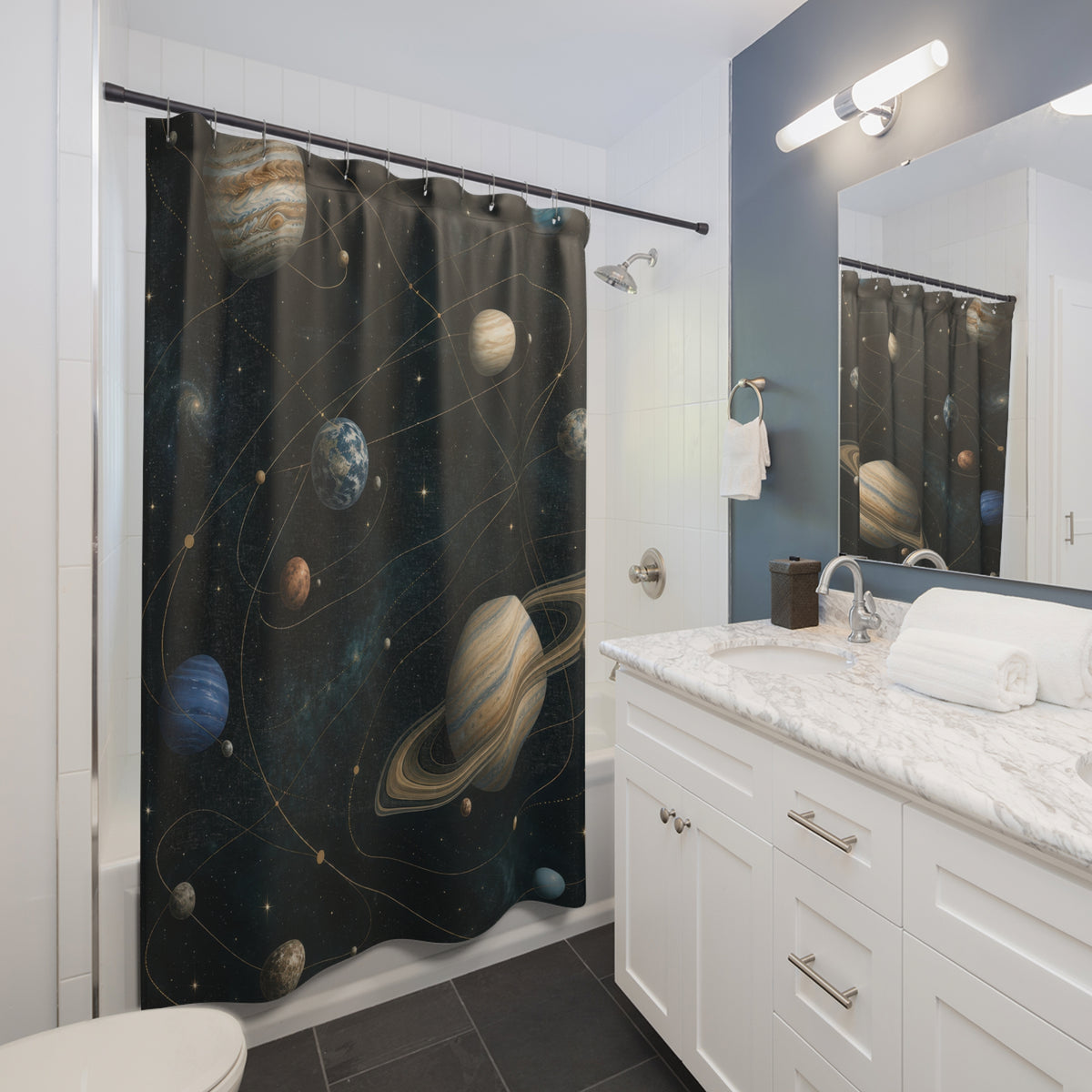 Blue and cream planets along gold orbits on dark teal shower curtain beside a white vanity
