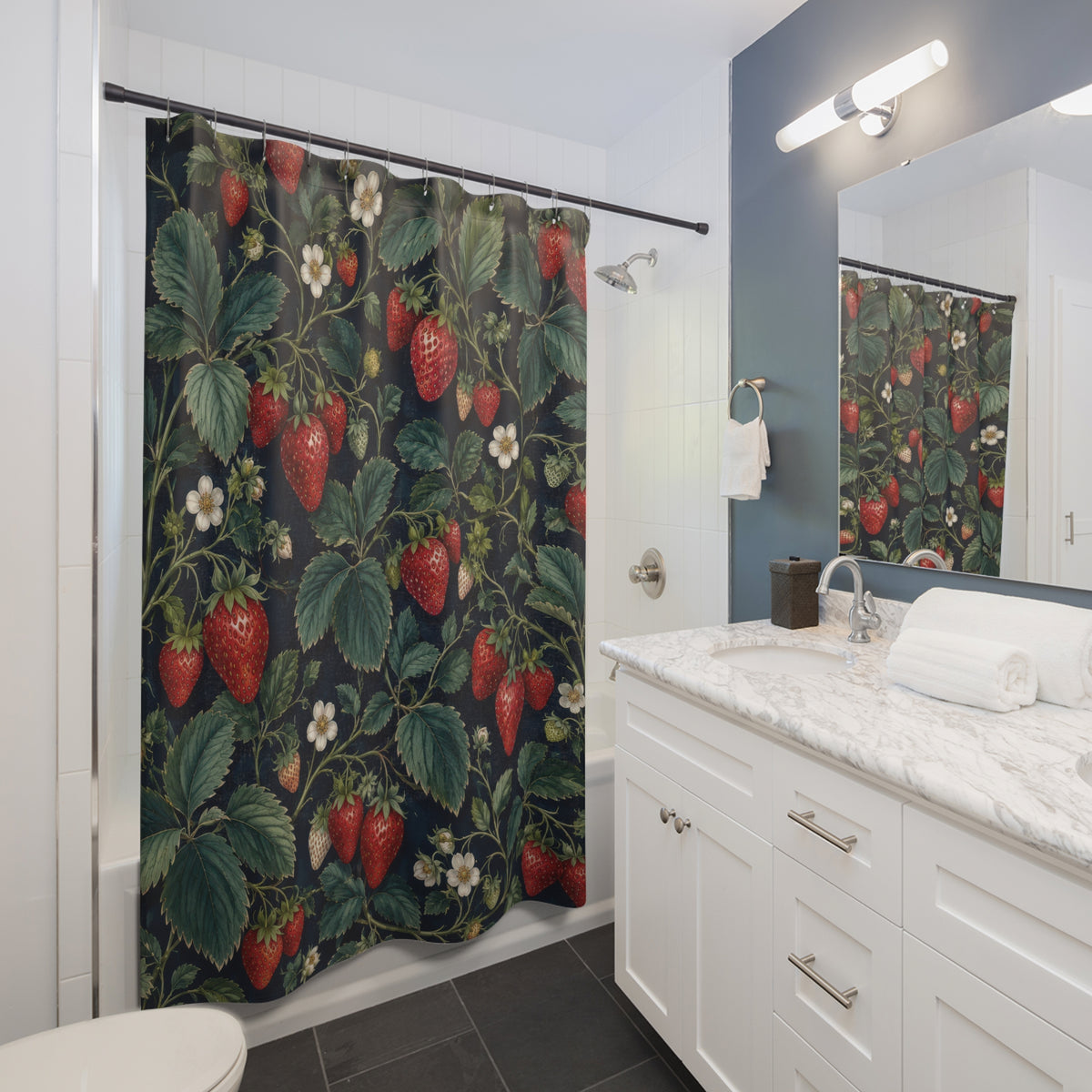 Red strawberry clusters with green leaves on navy shower curtain beside a white vanity