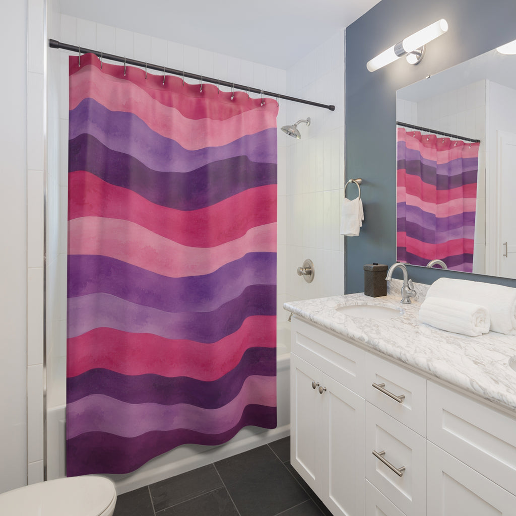 Wavy watercolor stripes in pink, lavender and plum shower curtain beside a white vanity