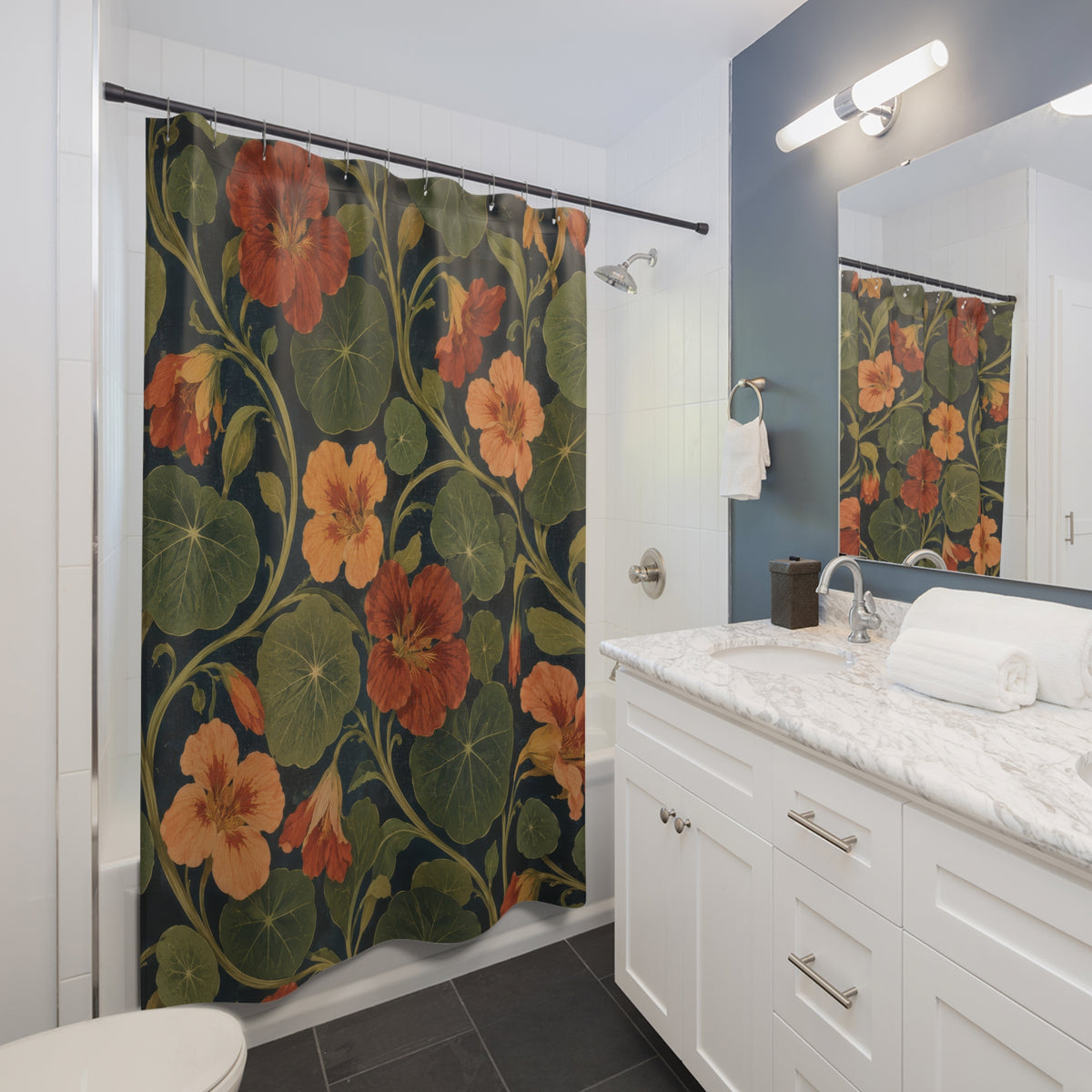 Rust nasturtiums and olive leaves on navy shower curtain beside a white vanity